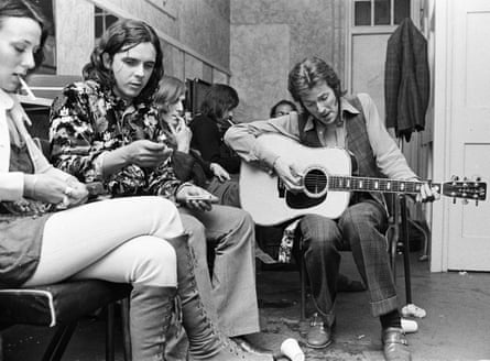 Eric Clapton playing the guitar next to a floral-shirted Whitlock in the dressing room of the Lyceum Ballroom, London, in 1970.