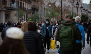 Pedestrians walk on a street in Barcelona, Spain, on 27 December.