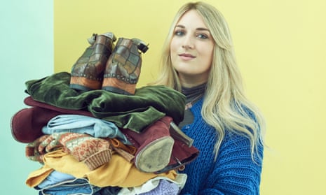 Lauren Bravo holding a pile of worn clothes.