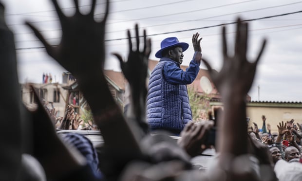 Raila Odinga waves to his supporters after casting his vote at a primary school in Nairobi.
