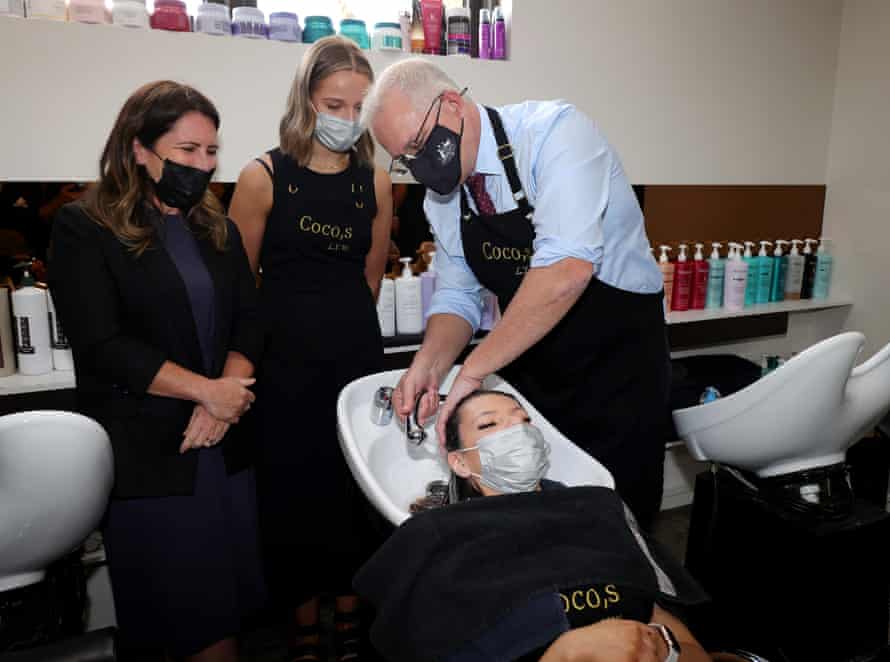 On the unofficial election campaign trail, Scott Morrison finally holds a hose in a photo op with Liberal candidate for Dunkley Sharn Coombes.
