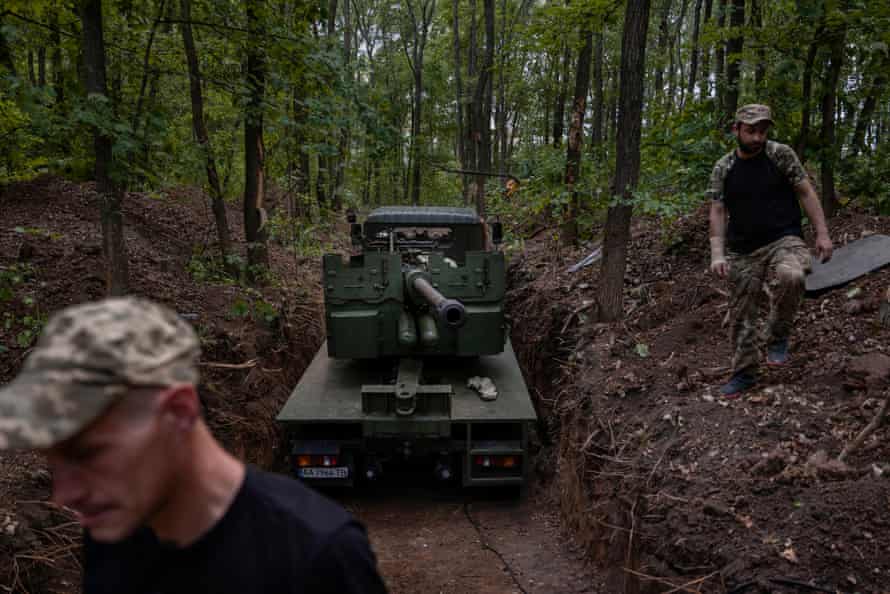 Ukrainian soldiers inspect an obsolete C-60 artillery piece that they have just repaired.