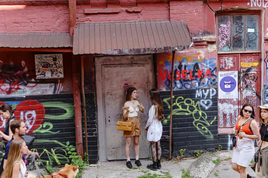 Festivalgoers chat in the factory courtyard.