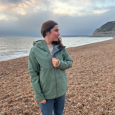 Writer testing the Tierra Roc Gen 4 women’s waterproof jacket while walking on a shingle beach on a dry but grey day.