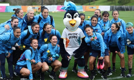 Tazuni, the official Women’s World Cup mascot poses with players of Argentina after an open training session earlier this month in Auckland