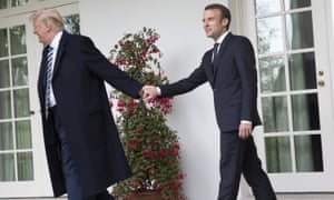 Donald Trump leads Emmanuel Macron by the hand.
