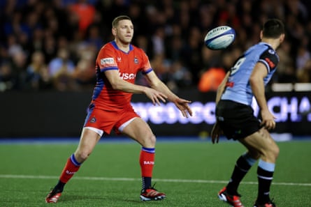 Finn Russell of Bath passes the ball while under pressure from Tomos Williams of Cardiff during their Champions Cup match