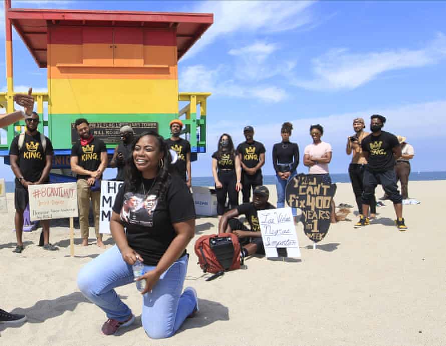 Lora King, Rodney King’s daughter, kneels as she addresses supporters at at a Black Lives Matter protest in the Venice Beach area of Los Angeles last year.