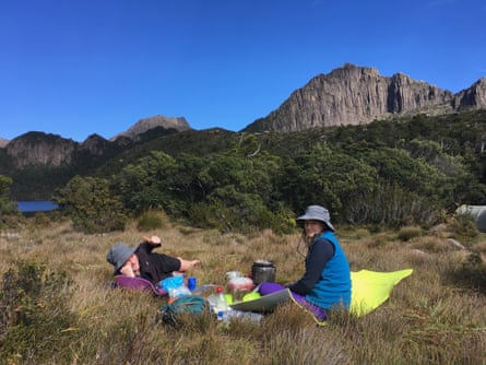 Lisa Walker and her son resting on the grass during their walk of Mount Lot, Tasmania.