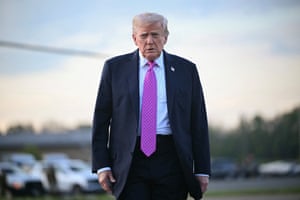 Trump wearing a dark suit and purple tie