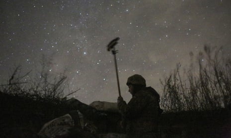 A member of the Ukrainian forces checks the situation on a frontline near Svetlodarsk, Ukraine.
