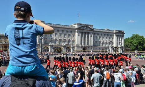 Tourists watch the Changing the Guard ceremony outside Buckingham Palace in London