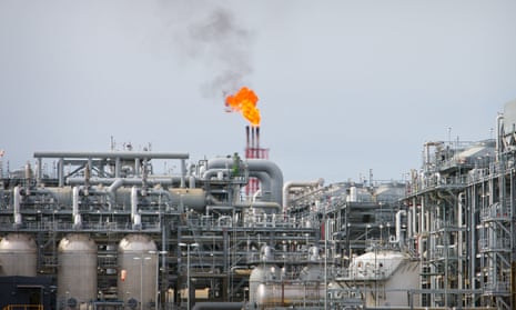 A flame blazes on top of flare stacks at a liquefied natural gas project site