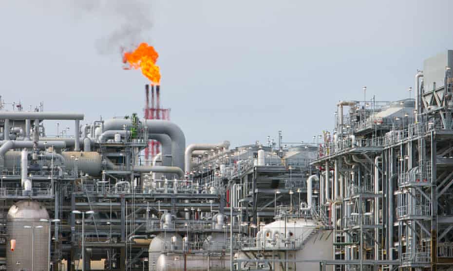 A flame blazes on top of flare stacks at the Queensland Curtis LNG site in Gladstone, Australia