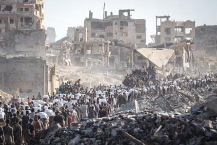Palestinians gather at an aid distribution centre