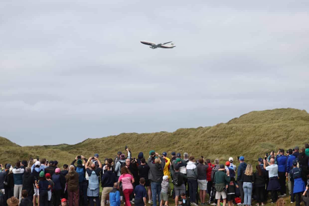 Spectators watch as Air Force One flies Trump over the Irish Open in Doonbeg, County Clare.