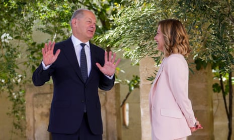 German Chancellor Olaf Scholz, left, is welcomed by Italian prime minister Giorgia Meloni during a G7 world leaders summit.