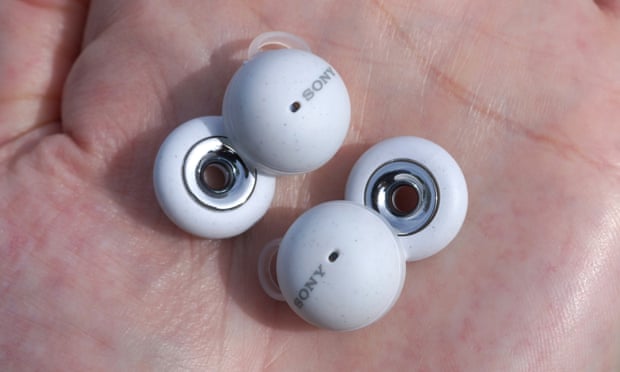 The Sony LinkBuds held in the palm of a hand showing their ring speaker shape.