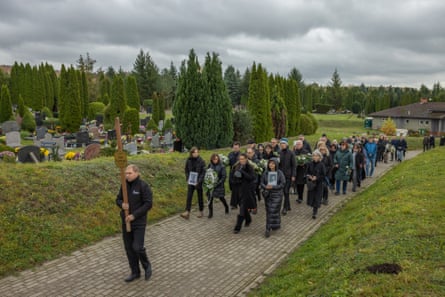 Mourners escort Jan Ledwoń’s ashes to the grave in Elbląg, northern Poland.