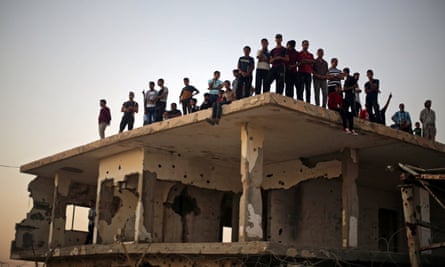 Palestinians on a damaged building at the Rafah border crossing in southern Gaza, 2017