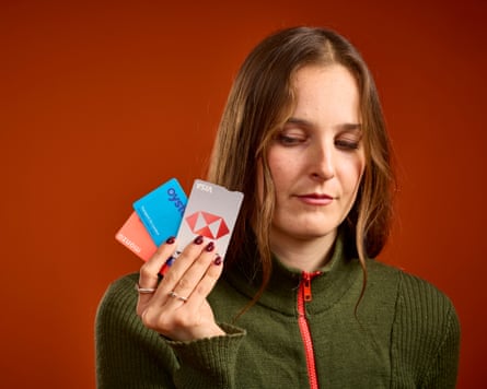 Emma holding up her bank card and Oyster card