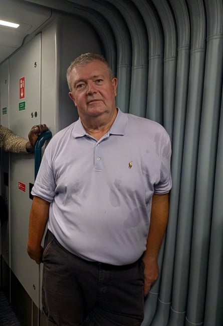Andy Simms standing in the space between two carriages