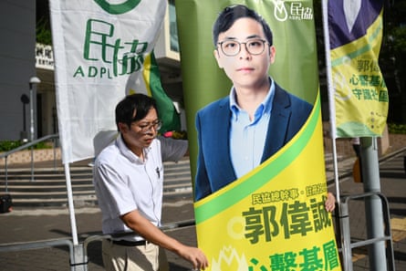 This photo taken on 26 October 2023 shows candidate Kwok Wai-shing putting up a banner of himself before canvassing for votes to compete for a seat in the Sham Shui Po East constituency in the coming district council poll in Hong Kong.