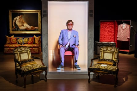A narrative video of Elton John greeting guests alongside his belongings for sale.
