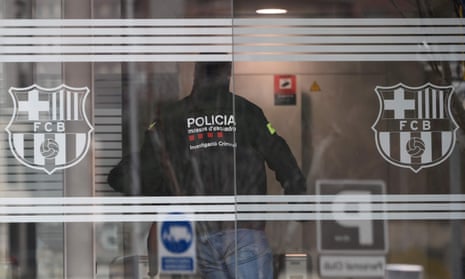 A policeman enters the Camp Nou offices.