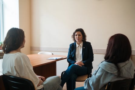 Psychologist Natalia Umerenkova during the session with Marina and Yulia (both with backs to camera) in Kyiv.