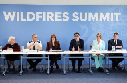 Andy Burnham speaking while seated with a panel