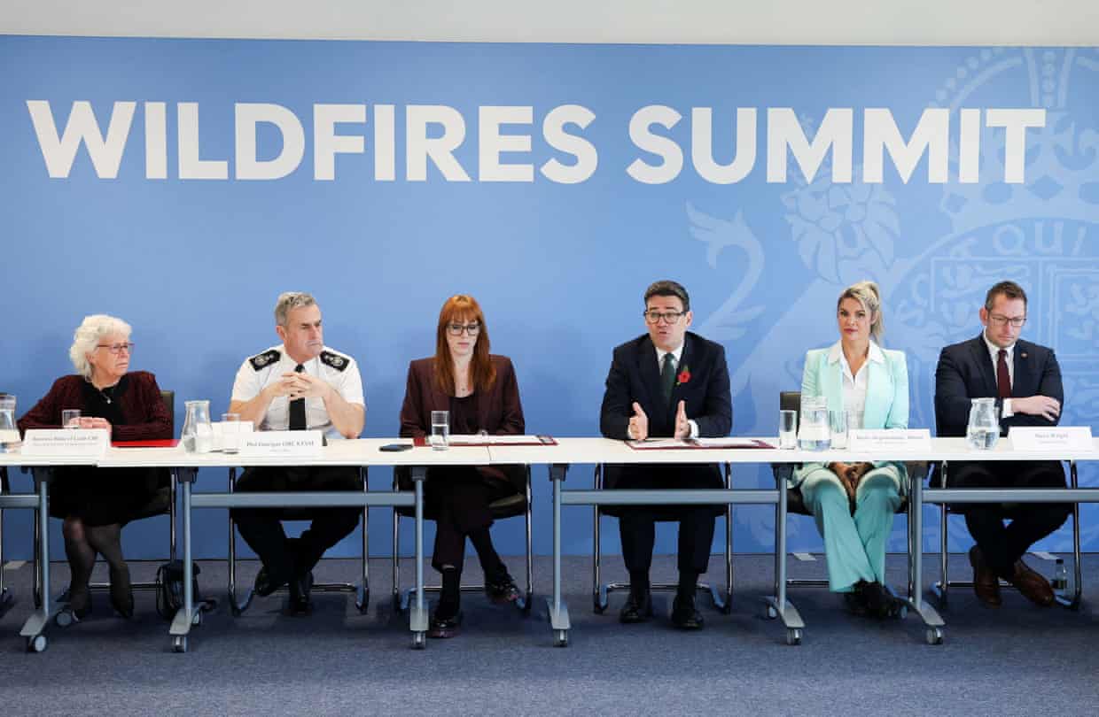 Andy Burnham speaking while seated with a panel