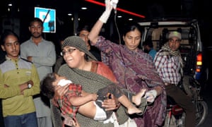 Woman carries injured child