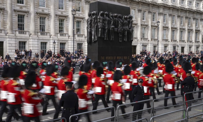 Soldiers from the Grenadier Guards march past the Cenotaph.