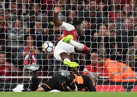 Danny Welbeck collides with Kasper Schmeichel as he scores Arsenal’s second goal.