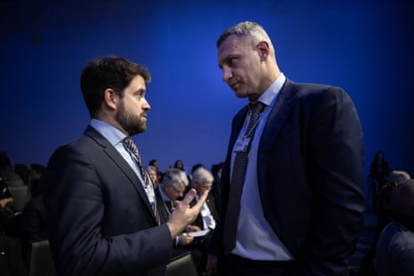 Kyiv mayor Vitali Klitschko (right) speaks to the Swiss MP Damien Cottier during the World Economic Forum’s annual meeting in Davos yesterday.