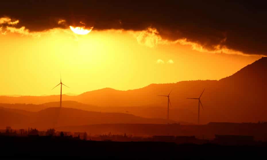 Power-generating windmill turbines at sunset near Larnaca, Cyprus.