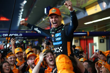 Lando Norris of McLaren celebrates with his team after winning the F1 world championship during the Abu Dhabi Grand Prix