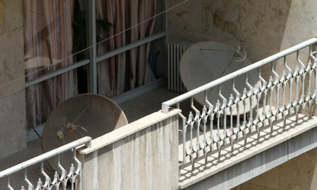 Satellite dishes such as those seen on a balcony in Tehran are widely used by Iranians to watch BBC news.