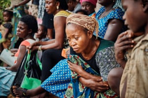 Cameroonian refugees in Cross River State, Nigeria, wait outside a health post in Ekang village