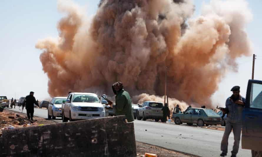 An airstrike by forces loyal to Gaddafi near a rebel checkpoint on a road outside Ras Lanuf, Libya in March 2011.