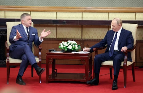 Slovak prime minister Robert Fico (L) and Russian president Vladimir Putin speak during a meeting at Diaoyutai State Guesthouse in Beijing, China.