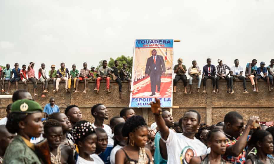 People holding the poster of Faustin-Archange Touadera, the president of the Central African Republic, at a campaign rally in Bangui, 12 December.