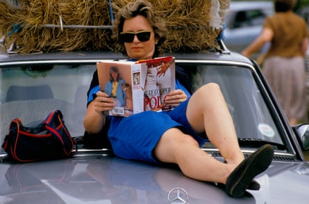 A fan reading Polo by Jilly Cooper at a polo match in the Cotswolds