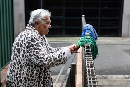 Carol attempts to remove the head of a mop which has rusted off.