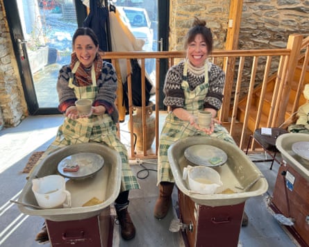 Two women make pottery