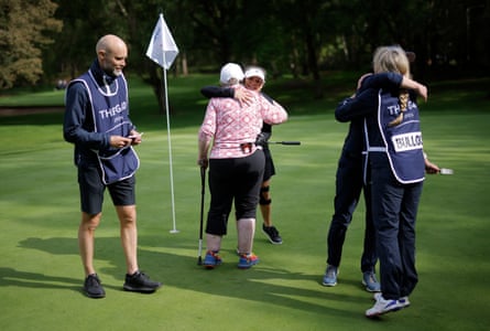 Martine Gilks from Coventry and Erika Malmberg from Sweden (centre), and Aimi Bullock and her caddy (right), embrace at the end of their round