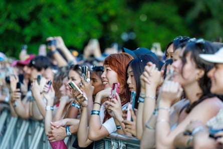 Young people with their phones at a music concert