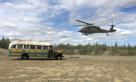 An Alaska Army National Guard helicopter prepares to remove the bus.