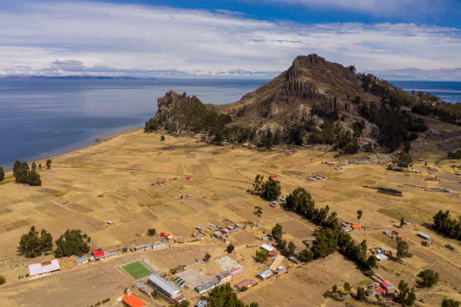 Santiago de Okola, beneath the Sleeping Dragon rock formation, on the shore of Lake Titicaca.